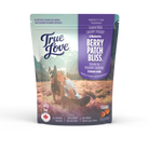 Bag of True Love dog treats with a girl and her dog on the front. Berry Patch Bliss - coated with creamy yogurt and blueberries.