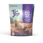 Bag of True Love dog treats with a girl and her dog on the front. Berry Patch Bliss - coated with creamy yogurt and blueberries.