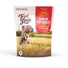 Bag of True Love dog treats with a scenic background. Harvest Supper flavour - savoury beef broth and garden carrots.