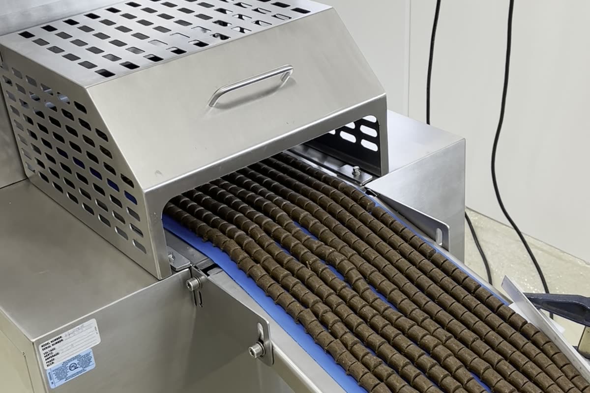 The depositor laying rows of soft chews onto the conveyor belt